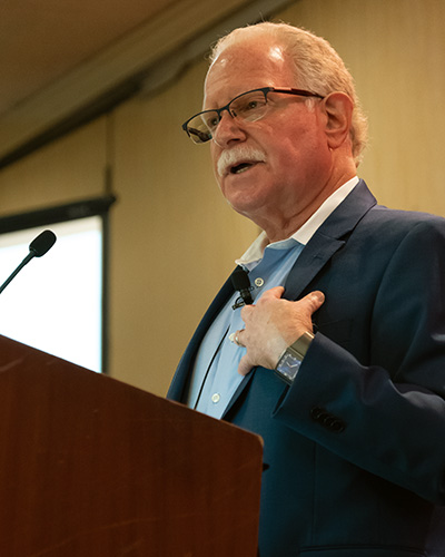 Dr. Scott Brandt speaking at a podium